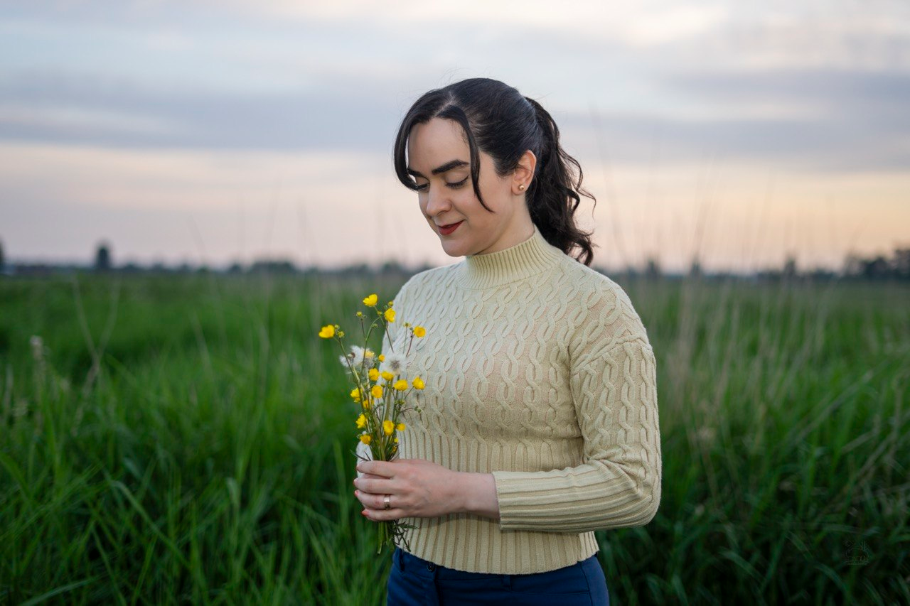 ChangeMoment founder holding flowers in a calm natural field
